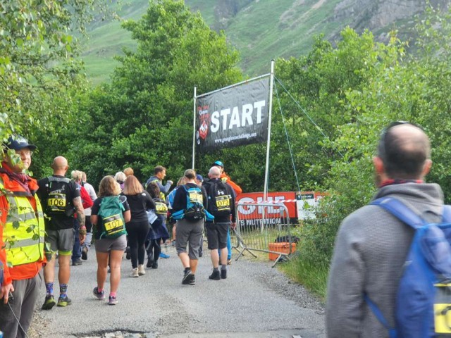 Crowd of people standing at the start of an event.