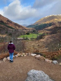 Girl looks out at railway bridge in the mountains