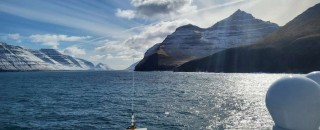 Island mountains rising out of the sea at the Faroe Islands