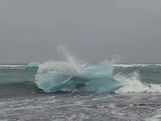 Waves break over a chunk of ice