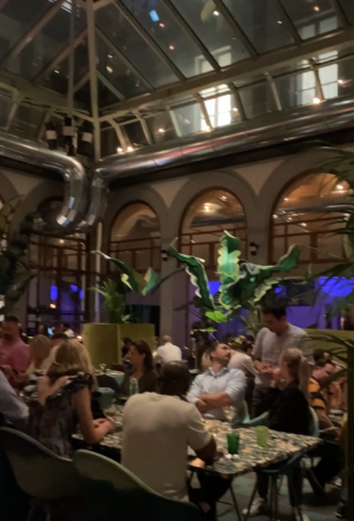 25Hours Hotel Restaurant with glass domed ceiling and tropical plants