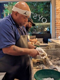 Lorenzo shucking oysters at Pesche Seafood Grill